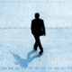 Silhouette of a business person walking on a large tiled floor with a prominent shadow, emphasizing professional growth and success in a corporate environment.