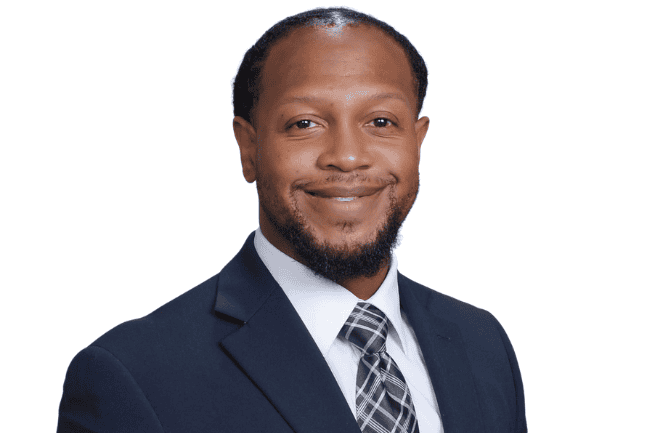 Diverse African American man in business suit, smiling confidently for leadership and community service image, emphasizing faith-based leadership, growth, and empowerment.