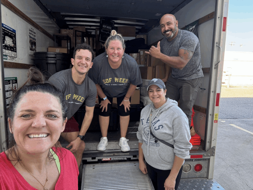 Volunteers packing supplies in a truck for charity event promoting community service and giving back.